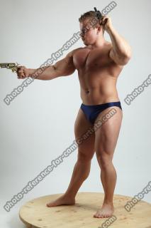 ADAM WARD STANDING WITH TWO GUNS